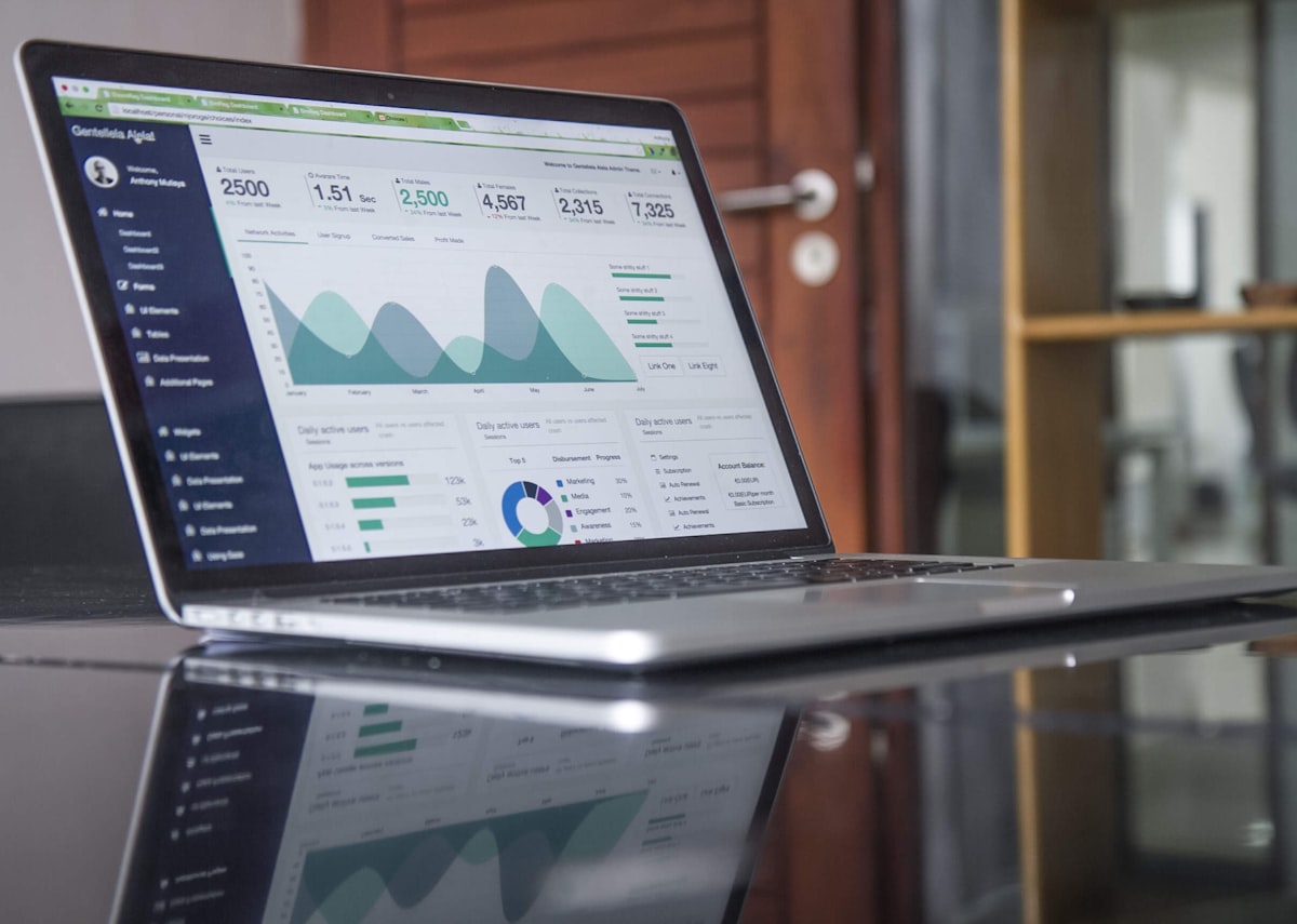 Business owner analyzing leads on laptop with growing charts in background